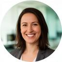 Keaira Giannakakos smiling in a corporate office with soft natural light