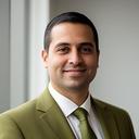 Operations manager portrait in a contemporary office with a neutral background and soft window light